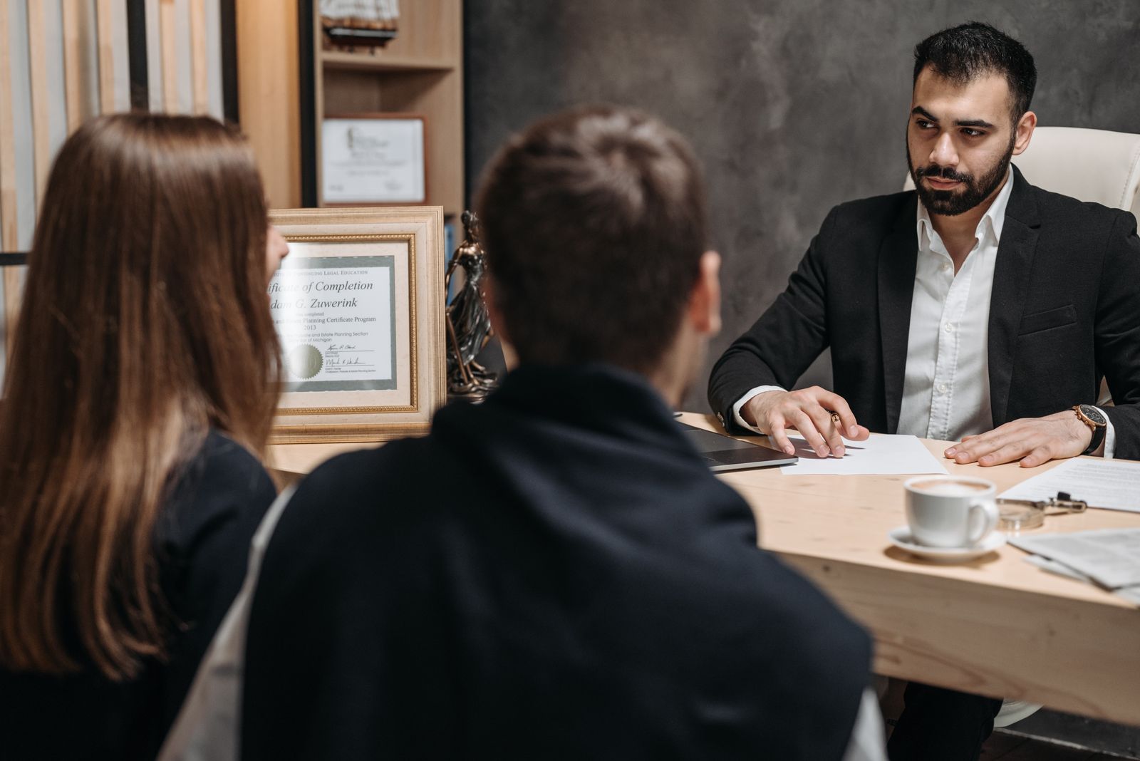A lawyer meeting privately with clients to review their legal matter.